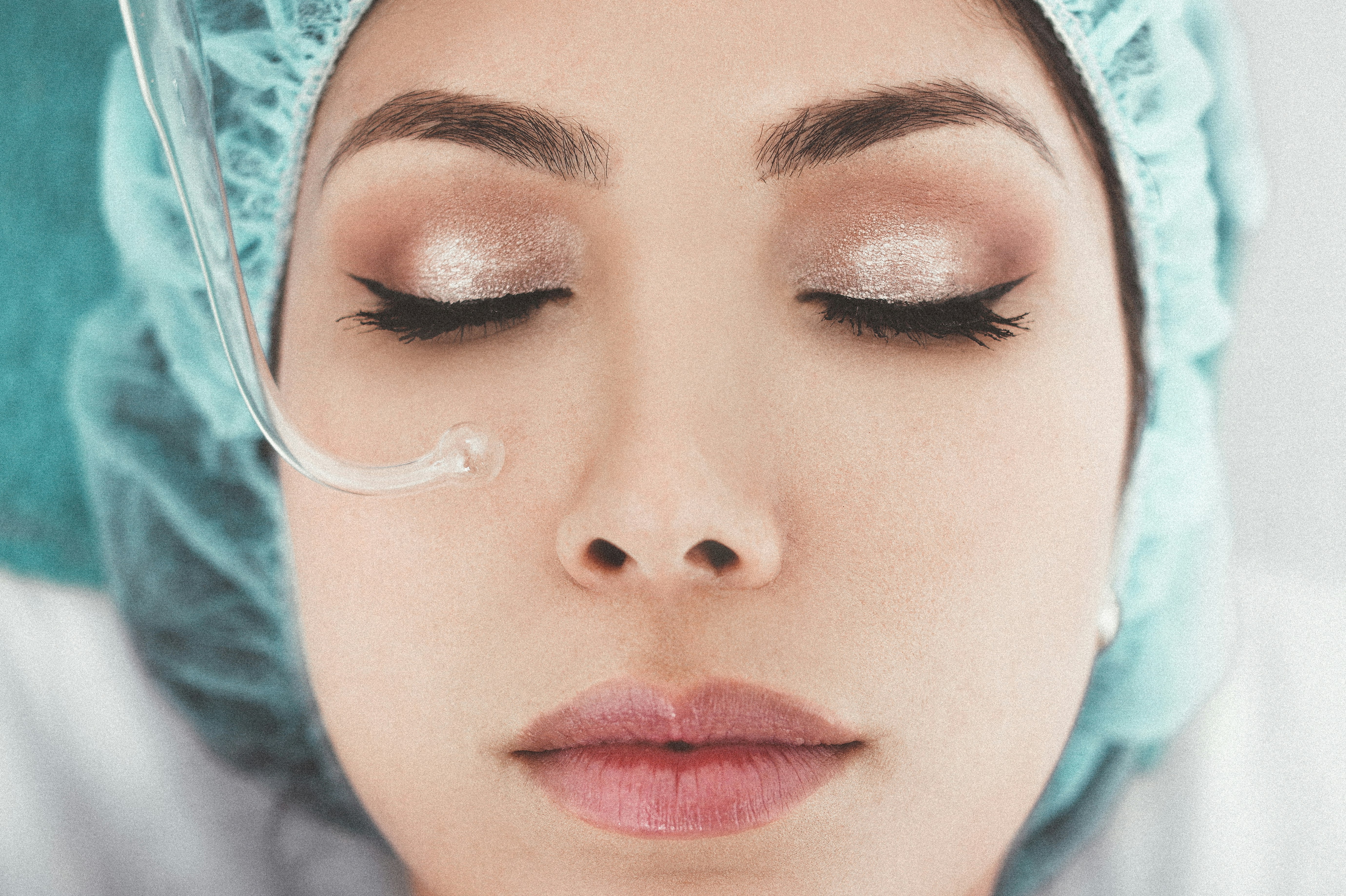 Woman in spa treatment gown undergoing pore purification treatment